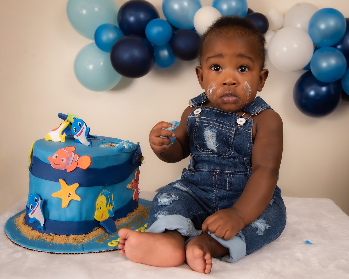 First birthday cake smash portrait with a blue cake