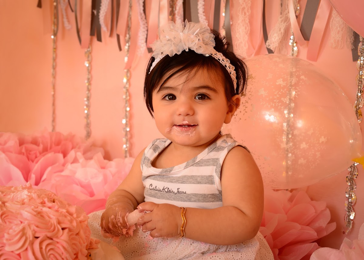 First birthday portrait with a pink cake