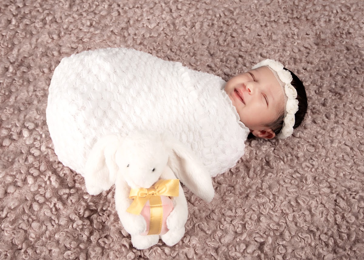 Wrapped smiling newborn baby portrait